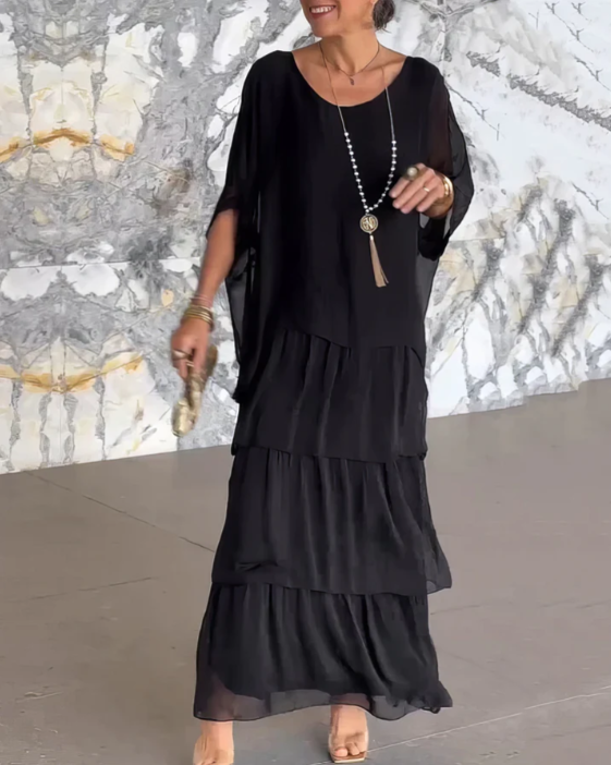 Detailed view of the elegant neckline of a chic women's long flowing maxi dress, perfect for fashion.