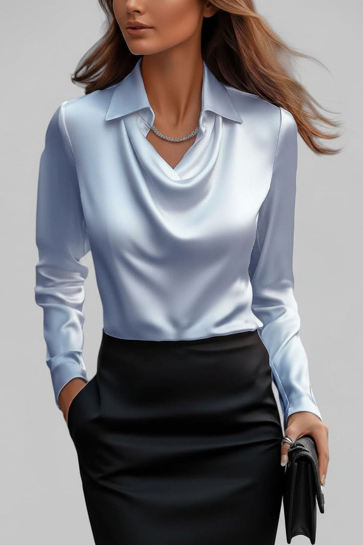 Fashionable ladies' blouse with elegant drapes and long sleeves, great for evening or office wear.