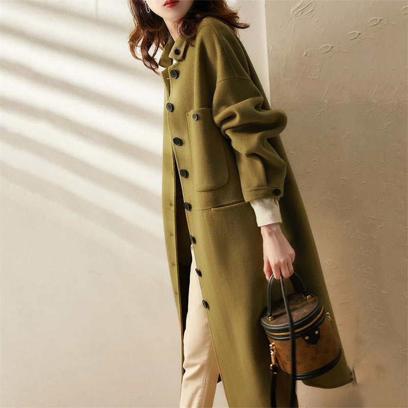 Chic black women's long trench coat, tailored for elegant formal attire or stylish casual fall/winter fashion.