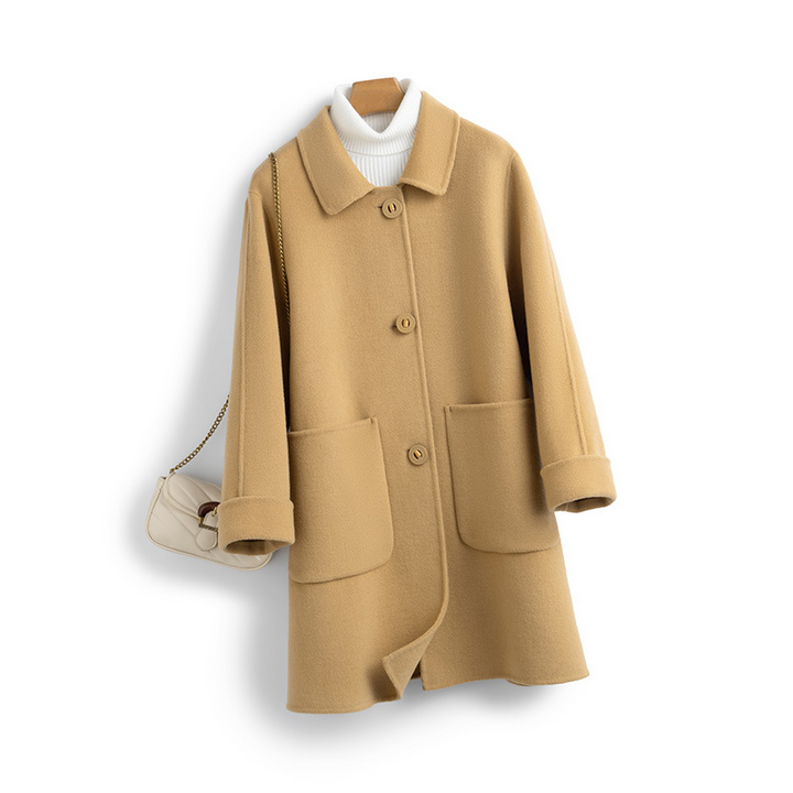 Luxury women's winter coat, made of soft cashmere with a graceful longline silhouette for modern women.
