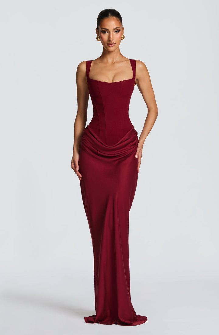 Elegant women's maxi dress with corset bodice, wide straps, and flowing skirt, perfect for formal evening events.