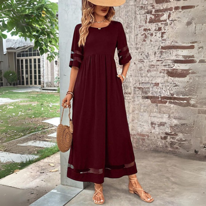 Stylish women's long dress; a modern maxi with see-through mesh panels and a comfortable, gathered waist design.