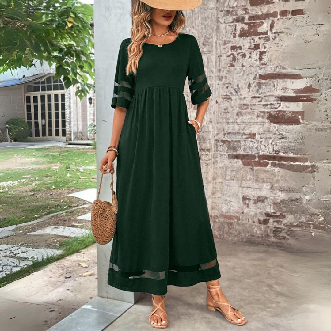 Flowing women's occasion maxi dress showcasing elegant mesh panels & a defining gathered waist, perfect for events.