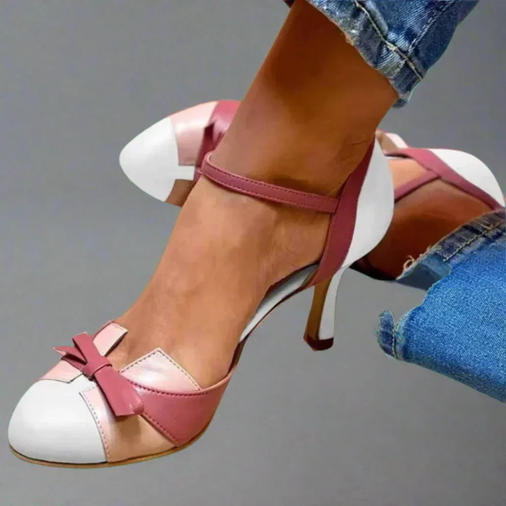 Women's sophisticated mid heel pumps featuring a chic bow strap. Versatile elegant footwear for dressy occasions or work.
