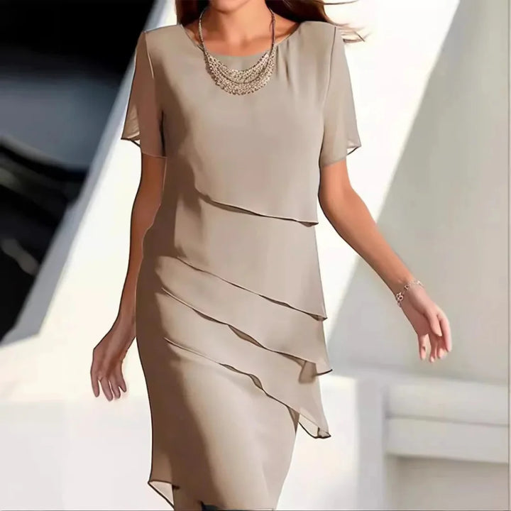Elegant women's midi dress with round neck & short sleeves. Versatile for day-to-night wear, comfortable summer style.