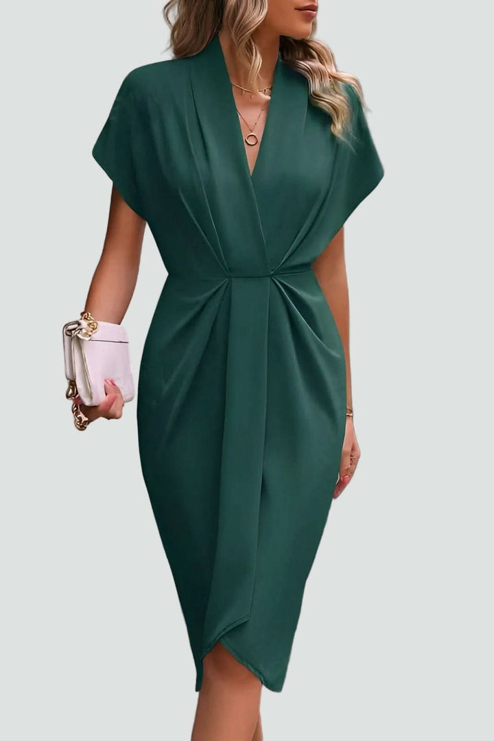 Woman models elegant V-neck midi wrap dress, showcasing its flattering silhouette & stylish design.