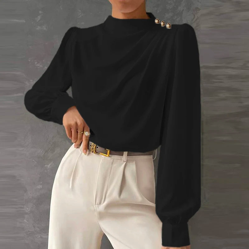 Chic women's mock neck blouse featuring elegant ruching, long sleeves, and distinctive gold button cuffs. Versatile top.