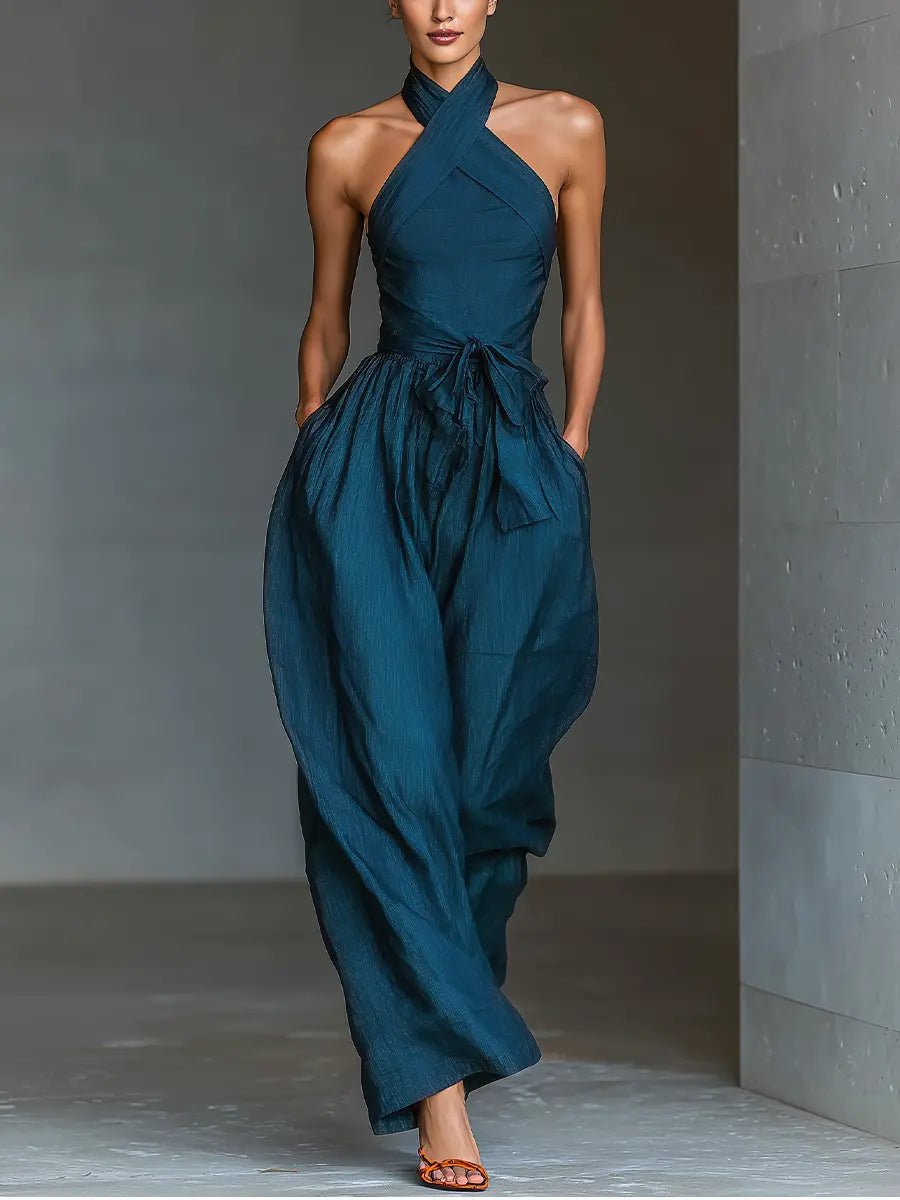 Elegant women's navy blue halter neck wide leg jumpsuit, sleeveless design for special occasions or formal wear.