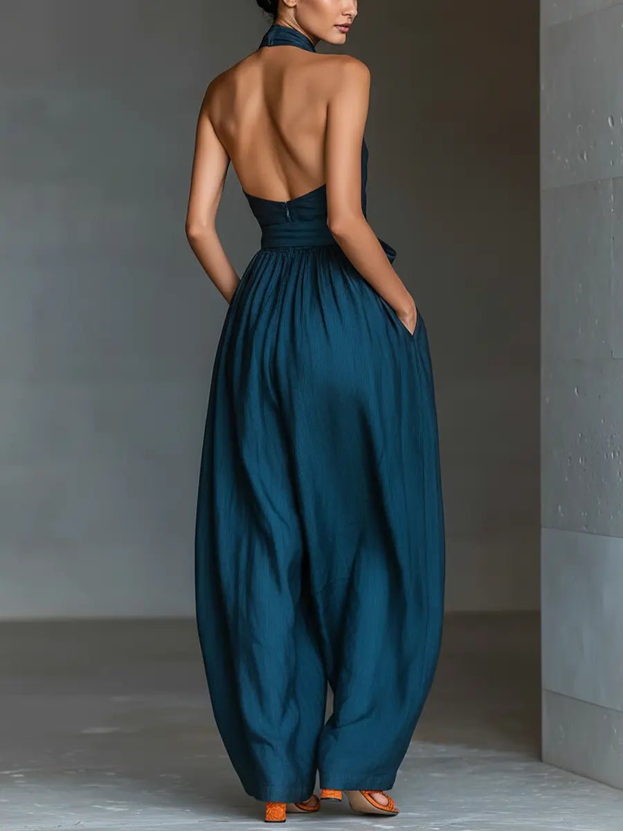 Modern women's navy blue sleeveless halter jumpsuit, showcasing a wide leg and elegant silhouette for fashion-forward looks.