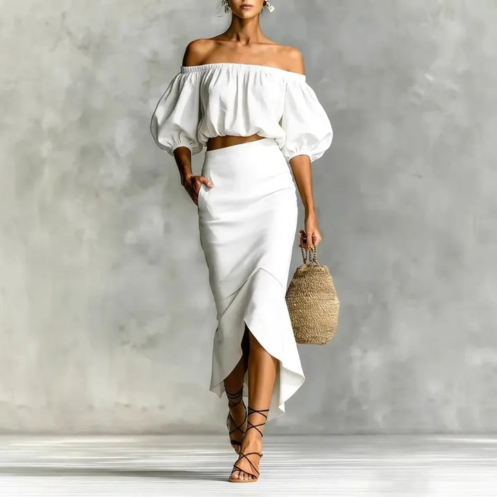 Stylish women's two-piece set featuring an off-shoulder puff sleeve crop top and flowing midi wrap skirt.