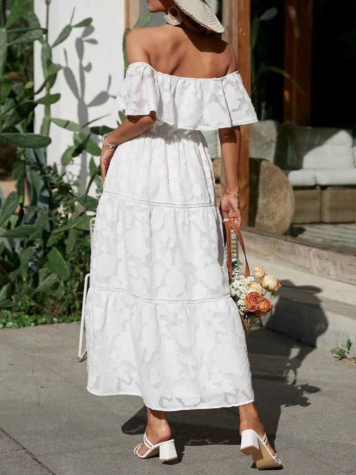 Beautiful wedding guest off shoulder maxi dress with a flowing tiered skirt and lace trim.
