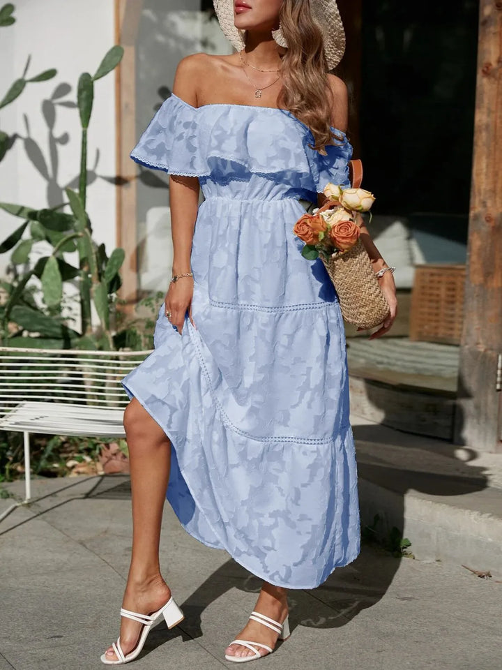 Fashionable off shoulder tiered maxi dress with elegant ruffles, suitable for events.