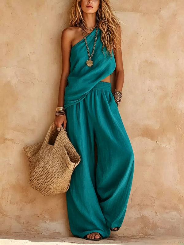 Flowing women's one-shoulder wide-leg jumpsuit, elegantly draped, perfect for summer resort or party.