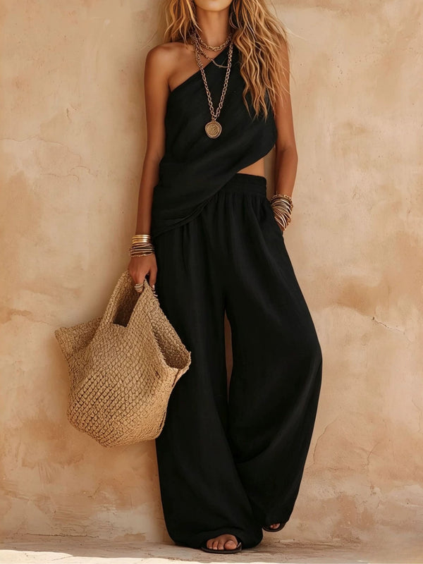 Resort wear women's one-shoulder wide-leg jumpsuit, elegant & flowing with a draped silhouette.