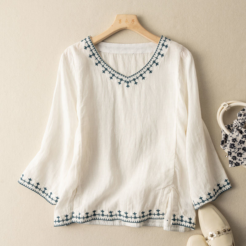 Elegant women's patterned V-neck blouse with short sleeves. Chic top for spring & summer fashion and everyday wear.