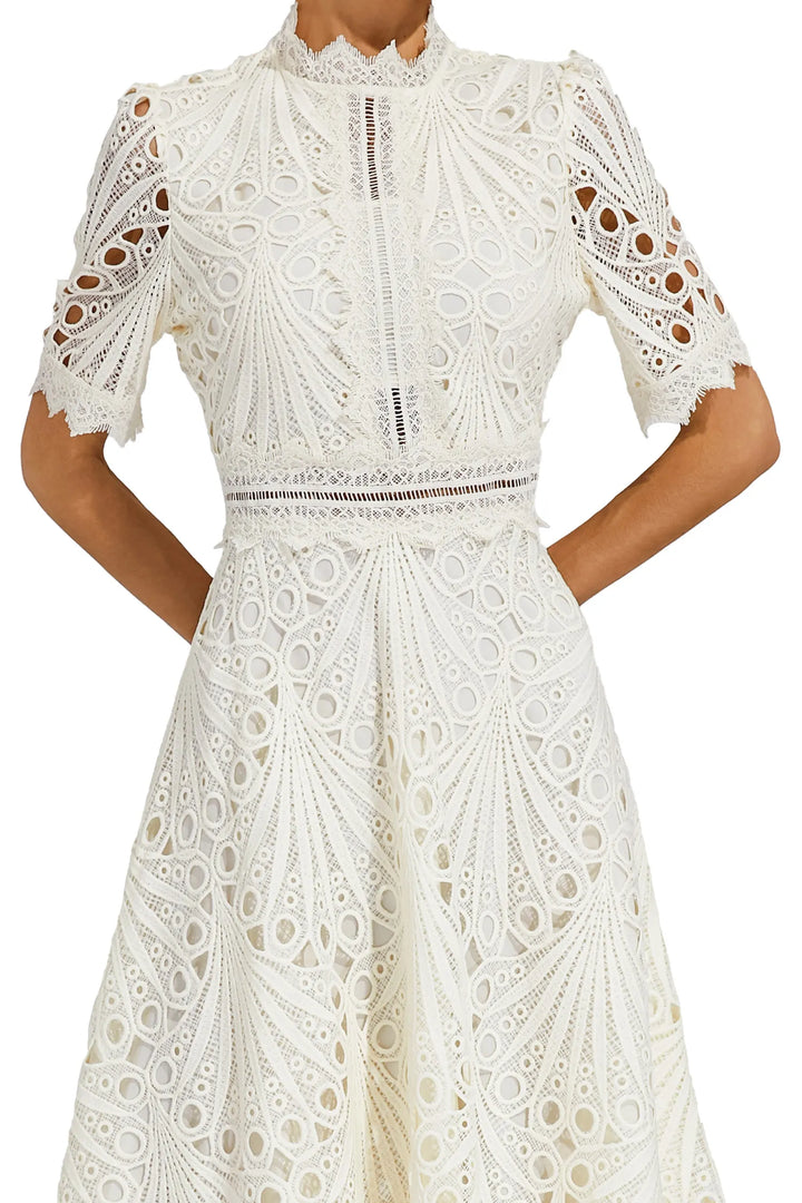 Intricate lace skirt detail of a women's pink midi dress, highlighting the quality and design