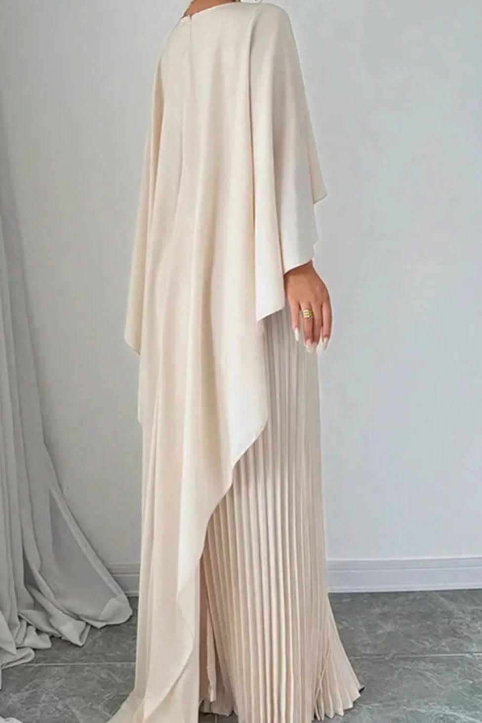 Sophisticated women's long evening gown with a flowing pleated cape design for formal special occasions.