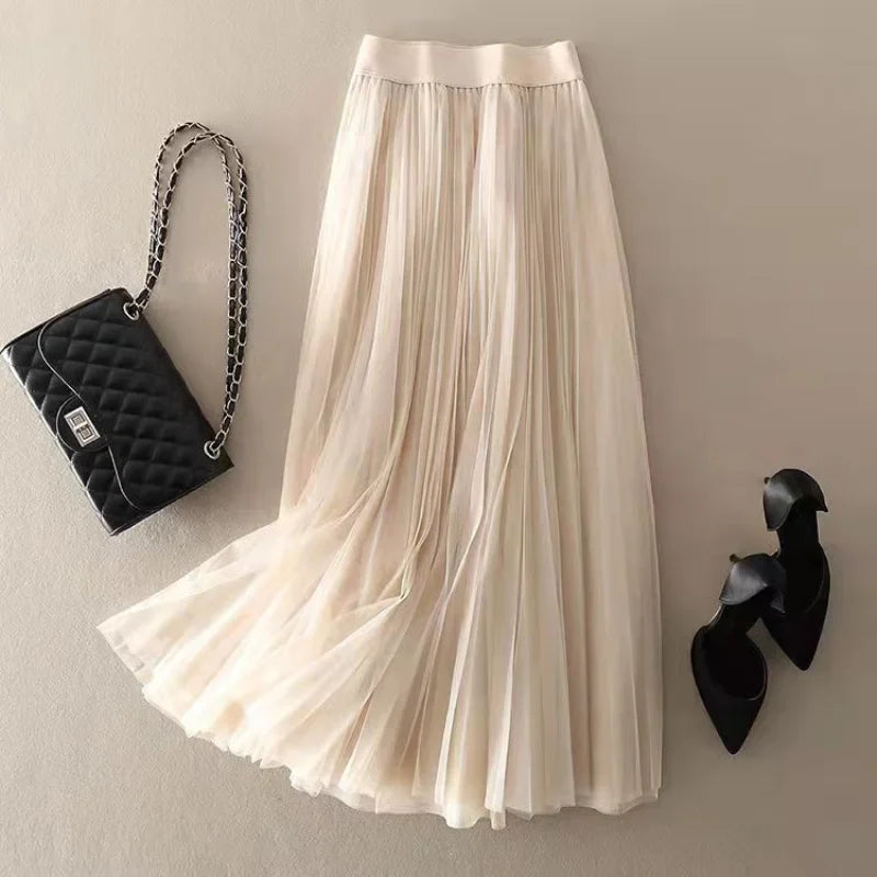 Beautiful women's elegant flowy pleated midi skirt. High-waist design for versatile and comfortable spring/summer style.