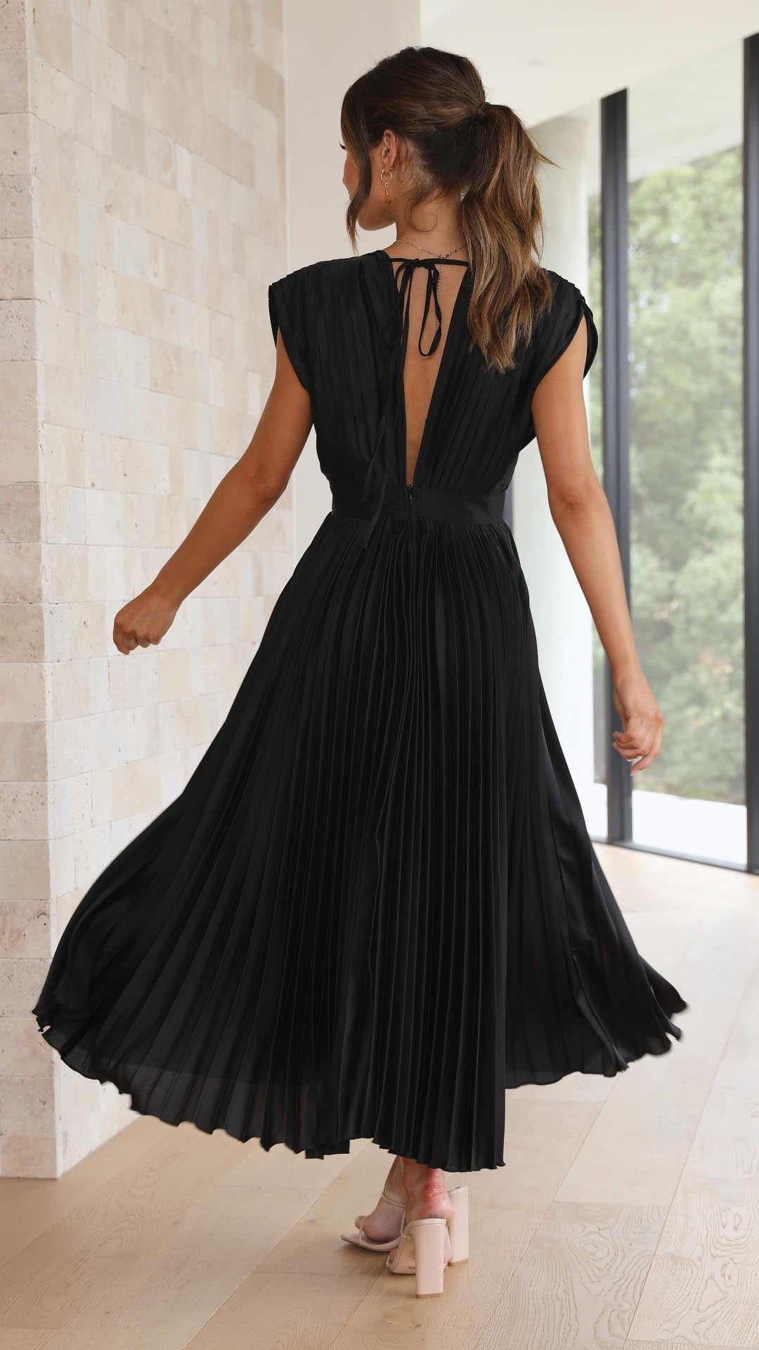 Women's elegant deep V-neck sleeveless pleated maxi dress, perfect for formal occasions.