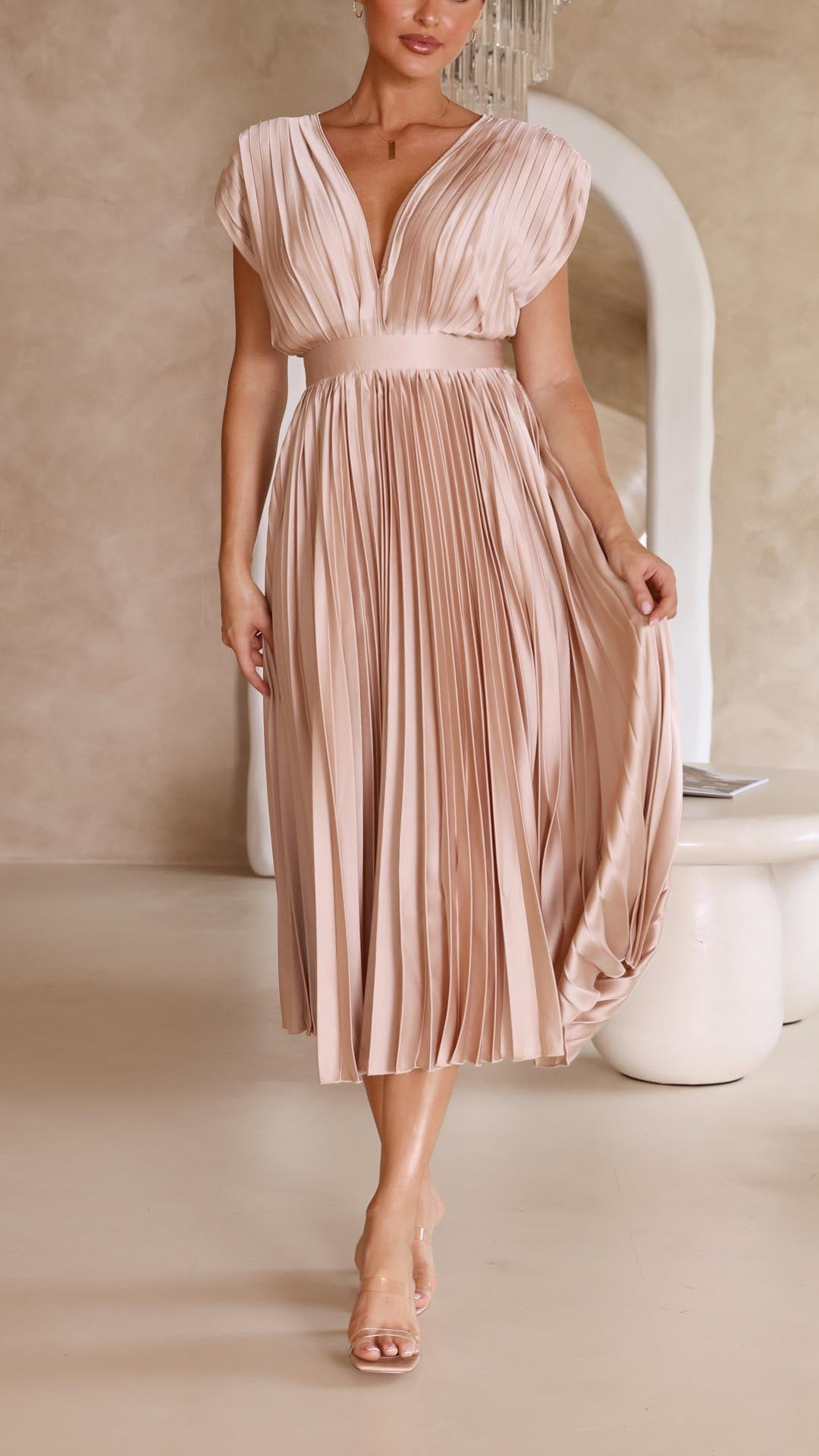 Elegant sleeveless maxi dress, pleated design, deep V-neck, ideal for wedding guest attire.
