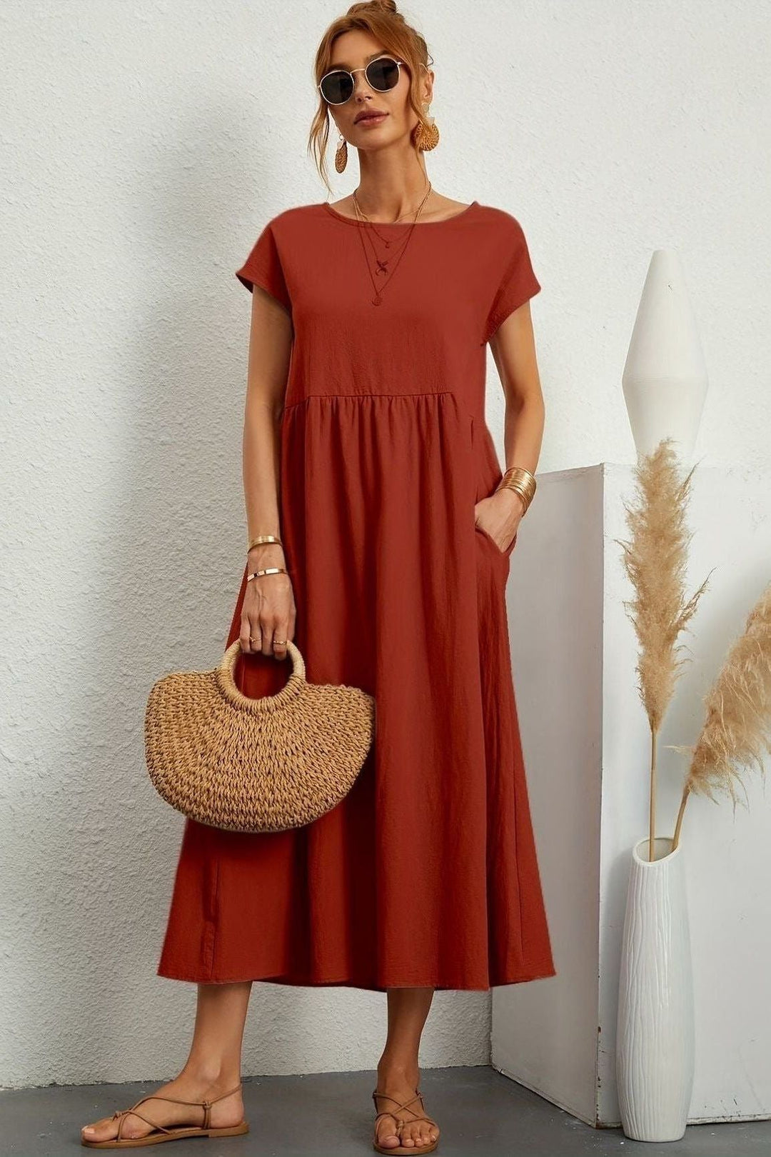 Side view of a women's pleated midi dress, highlighting the fluid movement of the comfortable fabric.