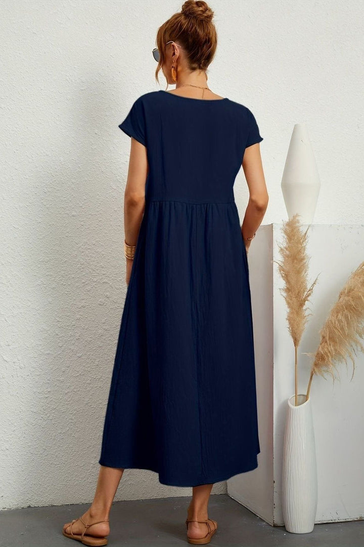 Women's pleated midi dress styled with accessories for a complete elegant casual or party look.