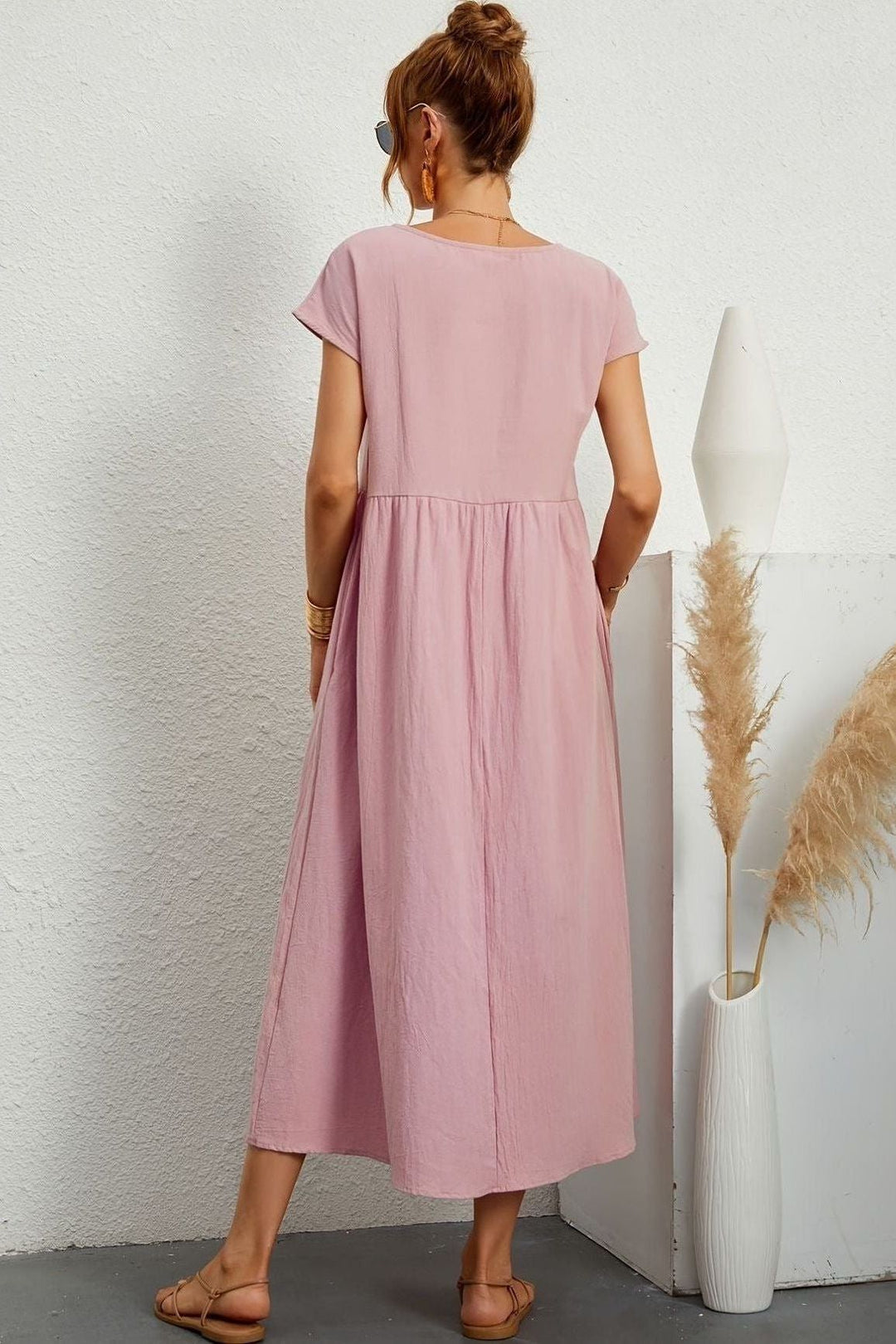 Effortless style in a women's elegant pleated midi dress, great for spring/summer comfort & fashion.