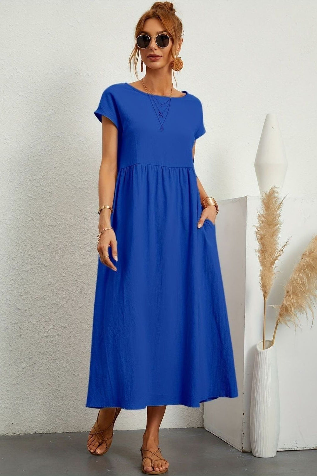 Relaxed fit women's pleated midi dress, offering comfort & versatile style. Great for any occasion.