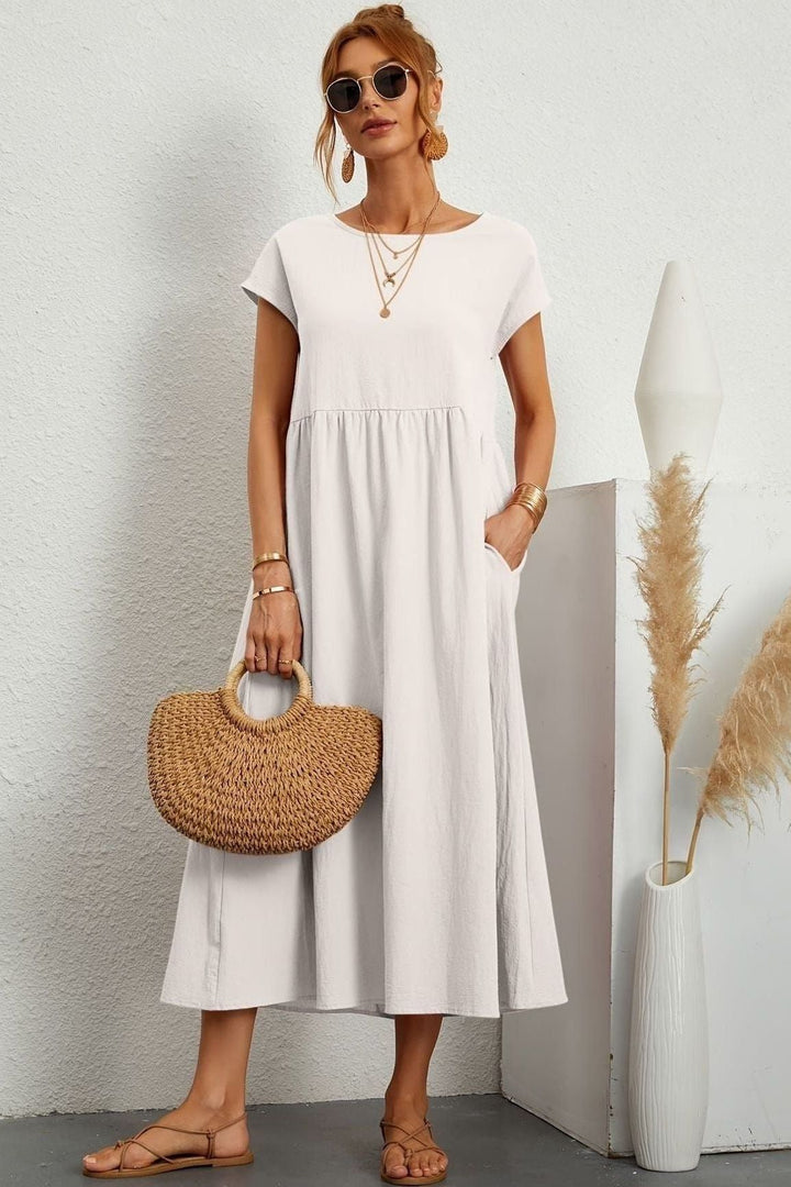 Elegant yet comfortable women's pleated midi dress for versatile spring/summer wear. Effortless style.