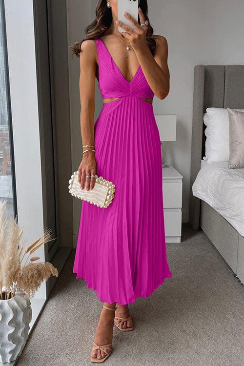 Close-up of elegant pleats on a women's flowing midi dress, highlighting the soft fabric and V-neck.