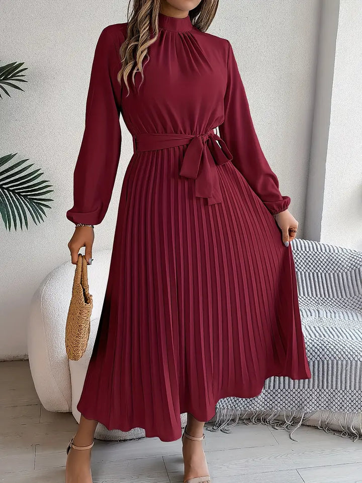 Women's modest pleated midi dress with long sleeves and an adjustable belt. Suitable for formal or casual.