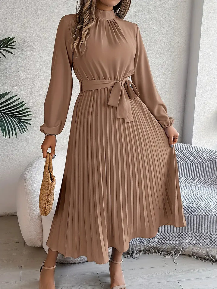 Flowy women's pleated midi dress with long sleeves. This elegant, versatile style includes a chic belt.