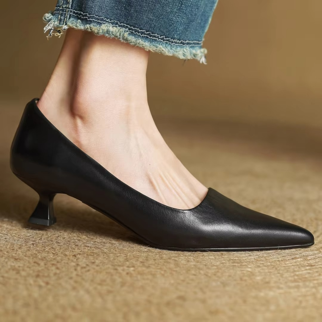 Fashionable women's pointed-toe pumps featuring a thin heel. Sophisticated shoes for professional settings & events.
