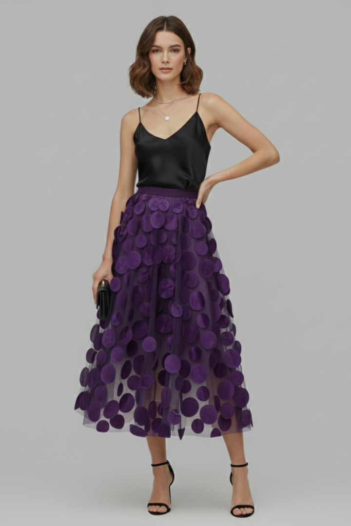 Women's elegant full polka dot midi skirt with a flowy design, ideal for modern fashion trends.