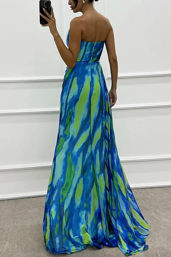 Sophisticated one-shoulder printed dress with feather trim. An elegant maxi wedding guest dress for women.