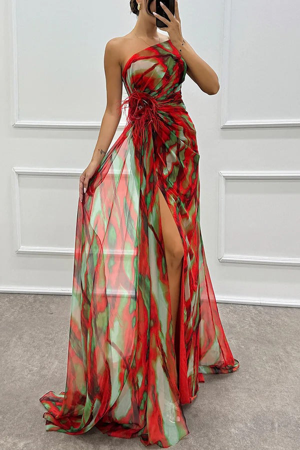 Stylish one-shoulder printed evening gown with feather accents. A chic formal dress for women's events.
