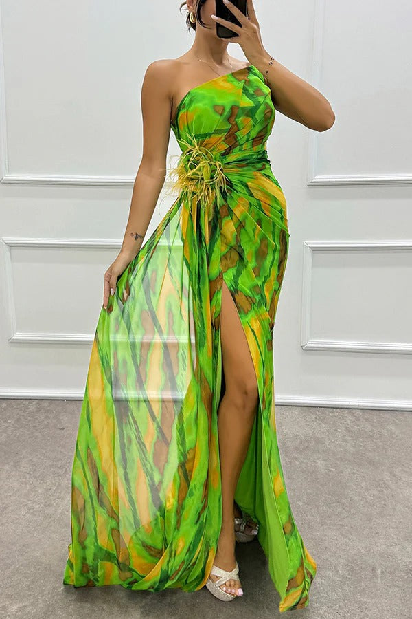 Chic women's elegant printed one-shoulder dress with feather detail, suitable as a sophisticated wedding guest dress.