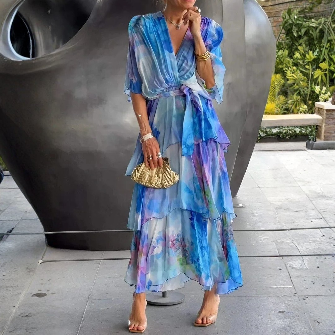 Stylish long tiered wrap dress for women with an elegant print. Ideal as a wedding guest or party dress.
