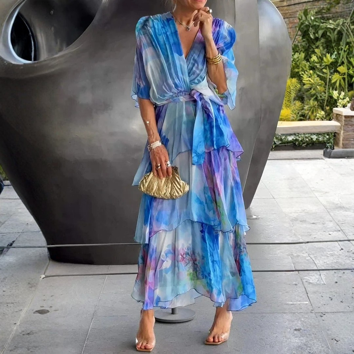 Stylish long tiered wrap dress for women with an elegant print. Ideal as a wedding guest or party dress.