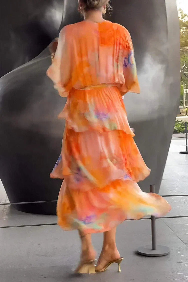 Vibrant orange printed tiered wrap dress. A stunning elegant long dress for women, ideal for parties and galas.