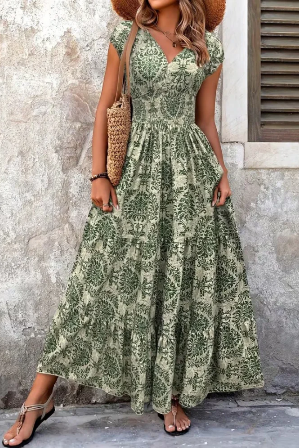 Women's vibrant printed v-neck maxi dress with a flowing silhouette. Ideal for summer casual wear or vacation.