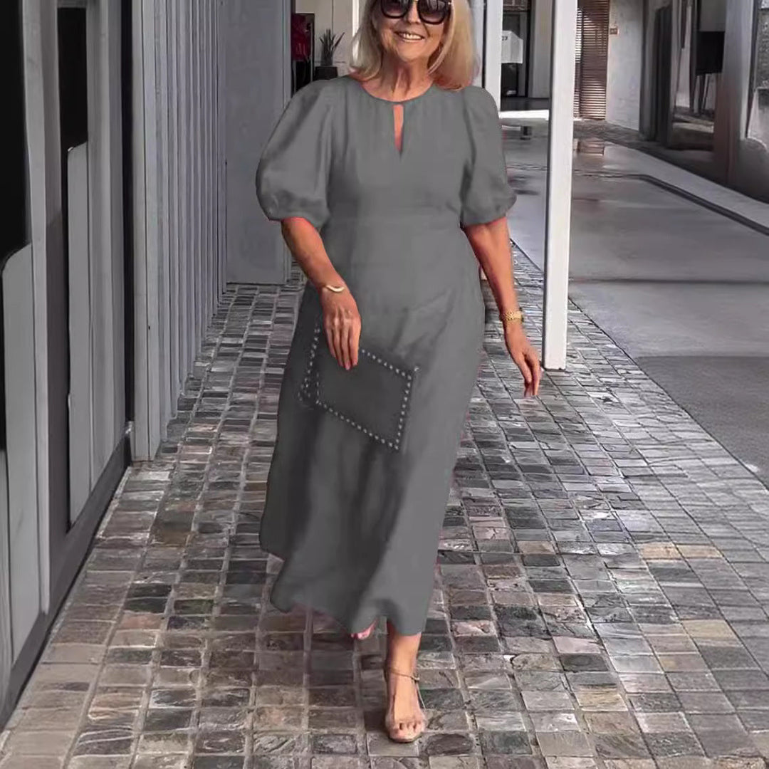 Fashionable women's elegant midi dress. Features a keyhole neckline, puff sleeves, and A-line cut.