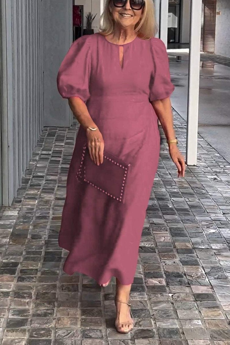 Women's elegant A-line midi dress with a tasteful keyhole neckline and fashionable puff sleeves.