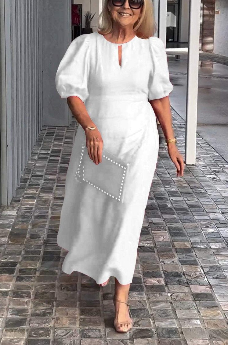 Graceful women's puff sleeve midi dress. A-line silhouette with keyhole detail, perfect for events.
