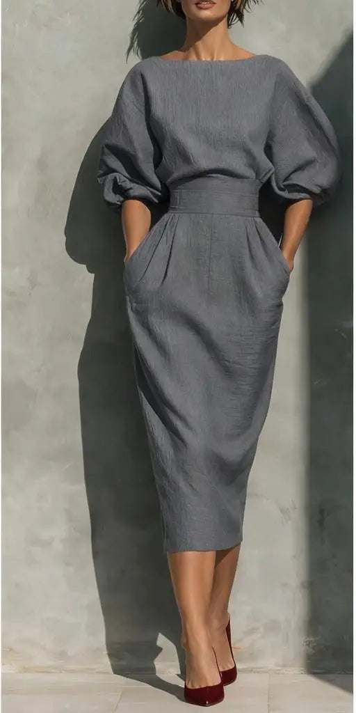 Round neck women's puff sleeve midi dress with practical pockets, a modern elegant choice for spring workwear.