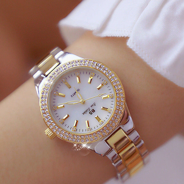 Elegant women's quartz watch with glossy stainless steel band. Analog display, water-resistant fashion accessory.