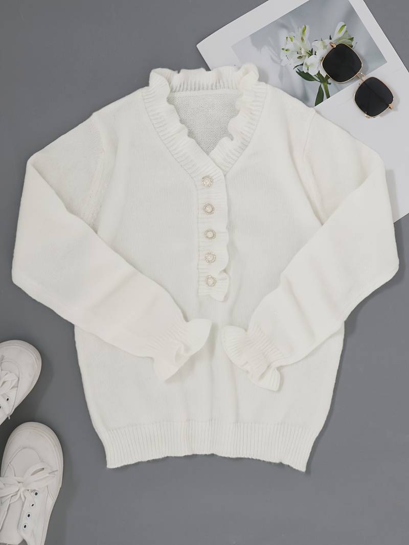 Close-up of a women's fashion blouse with intricate ruffle details and decorative buttons.