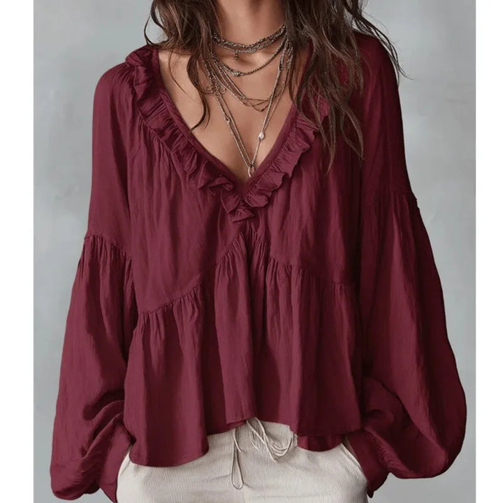Stylish women's long-sleeve ruffle blouse. Elegant V-neck, puff sleeves, & flowy design for casual or chic wear.
