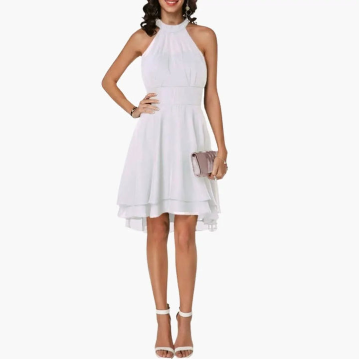 Graceful women's knee-length dress with elegant ruffles and a classic round neck. A chic sleeveless design.