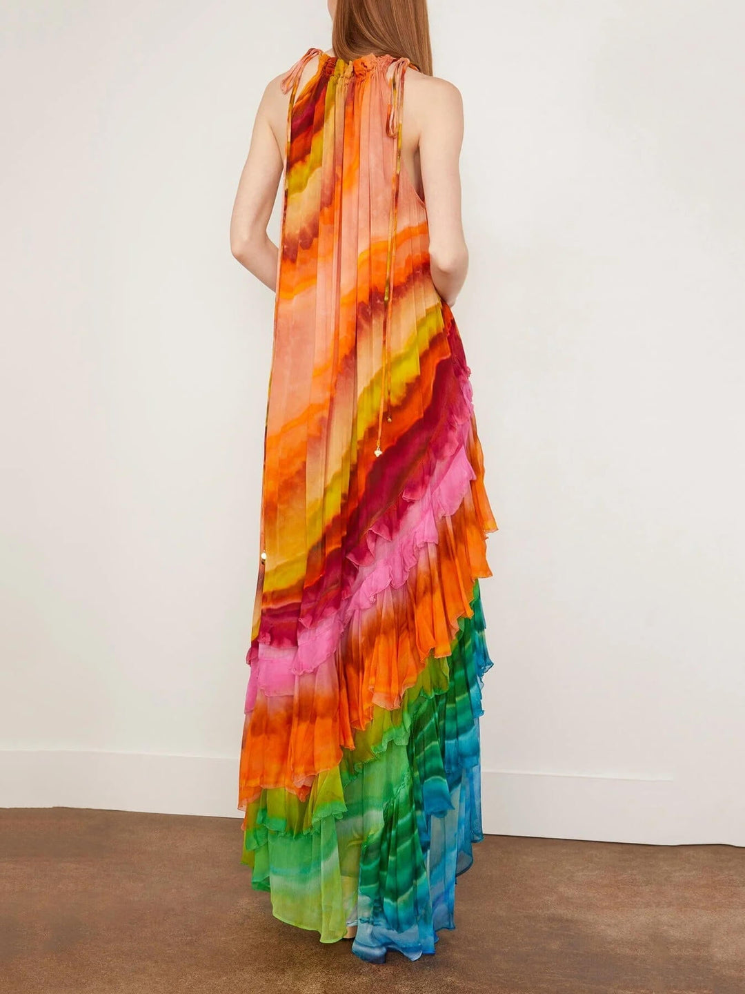 Long women's sleeveless halter dress featuring elegant ruffles & tiered skirt. Ideal for occasion wear and parties.